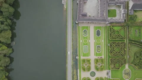 Top down drone shot of a straight road with gardens and river either side Stock Footage 301314665