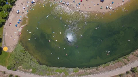 Top-down drone shot of swimmers and paddleboarders at Sandy Point Beach Stock Footage 339506339