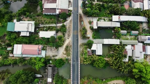 Top-down drone shot tilting up to reveal a rural road and canal network Vídeos de archivo 335984517