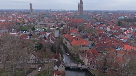 Top-Down Drone Shot of Tourist Boat on Bruges Canal Revealing Cityscape Stock Footage 325530878