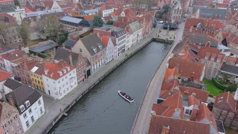 Top-Down Drone Shot of Tourist Boat on Bruges Canal Revealing Cityscape Stock Footage 325530968