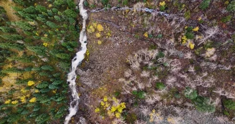 Top-down drone shot tracking forward over a rushing mountain waterfall in Stock Footage 323869376