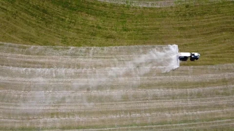 Top Down Drone Shot of Tractor Spreading Agricultural Lime on Grassland Video stock 347077147