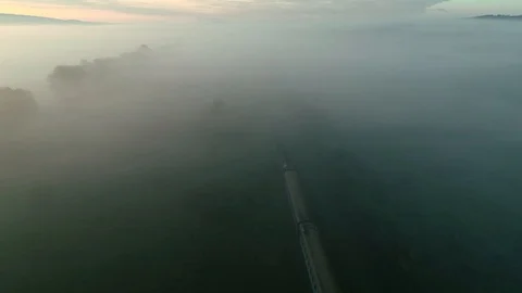 Top down drone shot of train moving in misty forest. 4K Stock Footage 116477540