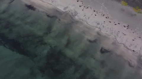 Top down drone shot of turquoise ocean waves crashing on Ersfjord sandy beach Stock Footage 340508013