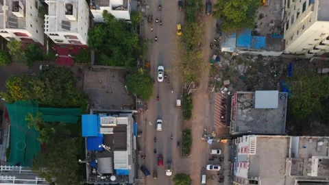 Top-Down Drone Shot of Urban Indian Street, Cars, Motorcycles, and Low-Rise Stock Footage 339644031