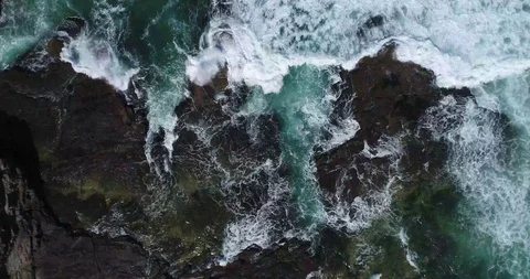 Top Down Drone Shot Waves Crushing against the rocks Stock Footage 115707537