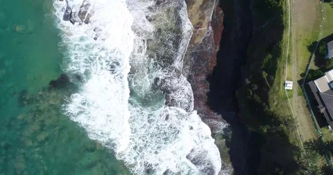 Top Down Drone Shot Waves Crushing against the rocks Video stock 115709567