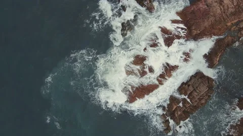 Top Down Drone Shot Waves Crash on Red Rocky Coast  ### 简单描述 Stock-Footage 232249016