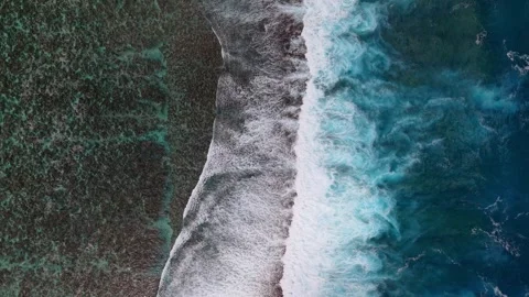 Top down drone shot of waves crashing 4K Stock Footage 308722056