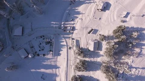 Top down drone shot of winter wonderland Gulmarg with frozen cars and trees. Stock Footage 311946798
