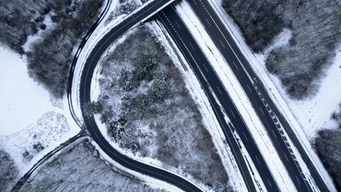 Top down drone shot of winter road and forest The Concept of Transportation Video stock 331925443