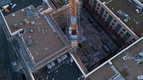 Top-down drone shot of yellow crane over derelict urban construction site Vídeos de archivo 307165878