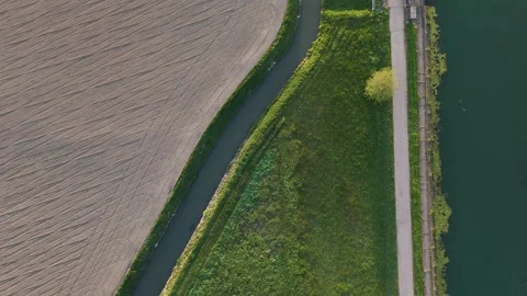 Top down drone slide over Milano-Cremona-Po Canal and agricultural waterways Stock Footage 340603918