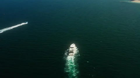 Top down drone tilting up from yacht to Dubai bay and boats Video stock 345097494