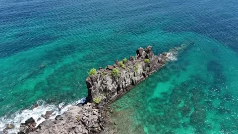 Top down drone tracking perspective over a jagged volcanic rock formation Stock Footage 337160802