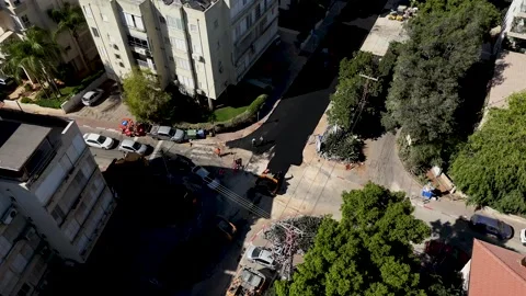 Top-down drone tracking shot of asphalt delivery truck laying fresh road Stock Footage 339106479