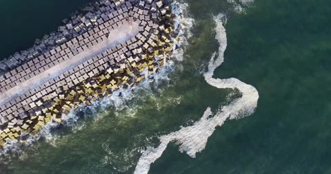A Top Down Drone Video of a Jetty with Crashing Waves. Concept The power of.. Stock Footage 313869878