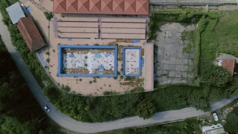 Top Down Drone View of Abandoned Pools and Mountain Hotel Stock Footage 340358619