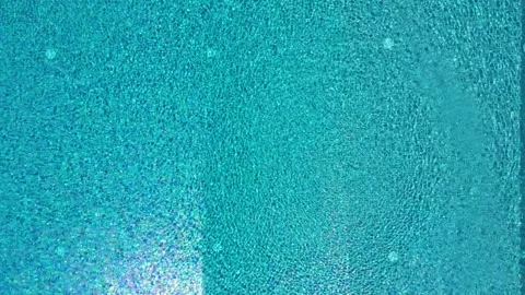 Top-down drone view ascending over rectangular modern swimming pool with clean Stock Footage 321371955