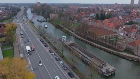 Top-down Drone View: Barge Moving Through Bruges Canal Revealing Cityscape Stock Footage 325531267