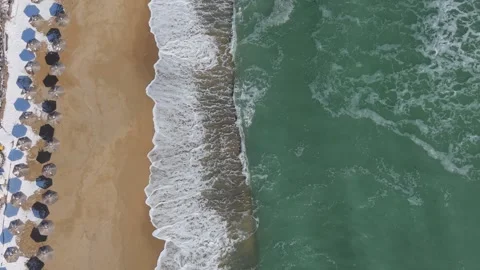 Top Down Drone View Of Beach Umbrellas And Emerald Waves Stock Footage 328283065