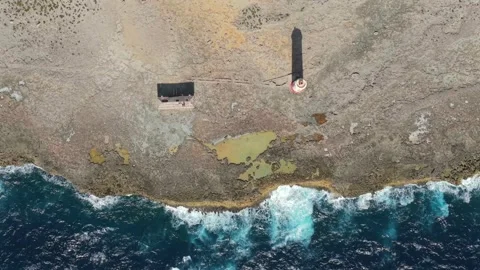 Top Down Drone View Of Bonaire Lighthouse And Rugged Coast Stock Footage 337054338