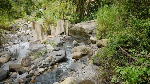 Top-down drone view of boulder-strewn creek with clear running water Stock Footage 316112417