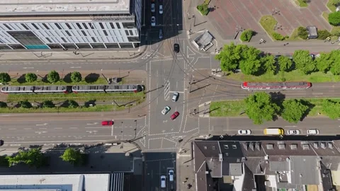 Top-down drone view of busy traffic intersection with trams in city center 스톡 동영상 309233670