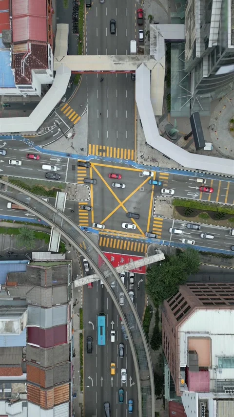 Top-down drone view of busy road intersection with cars in downtown Kuala Lumpur Stock Footage 313855375