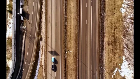 Top down drone view of car driving on highway in winter landscape Stock Footage 331070524
