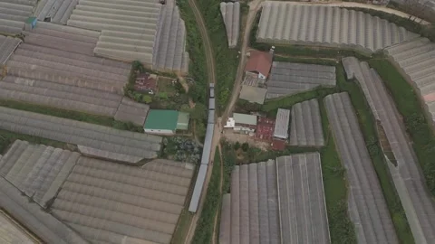 Top-down drone view chasing moving train in Da Lat, Vietnam Stock Footage 319910128