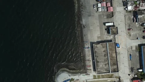 Top-down drone view of coastal promenade and traditional fishing boats. Stock Footage 336927462