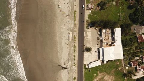 Top Down Drone View of Coastal Road, Sandy Beach and Shoreline Infrastructure Stock Photos