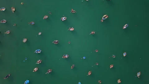 Top Down Drone View of Colorful Fishing Boats Floating on Emerald Sea in Vietnam 動画素材 340487402