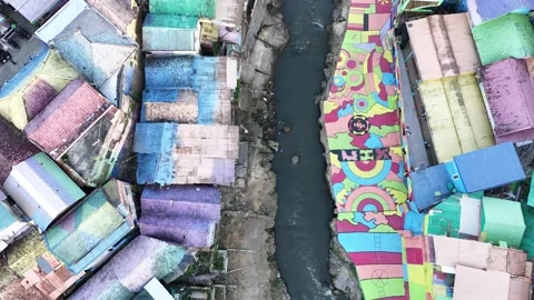 Top Down Drone View of Colorful Riverside Neighborhood in Indonesia Stock Footage 340542472