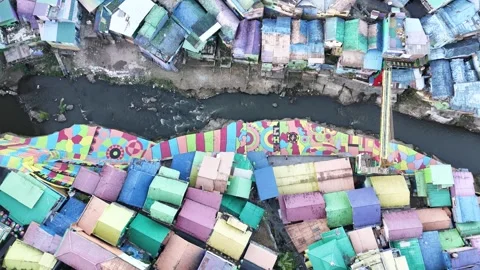 Top Down Drone View of Colorful Riverside Neighborhood in Indonesia Stock Footage 340542653