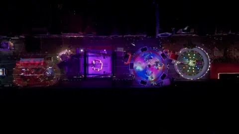 Top down drone view of colorful illuminated fairground at night Видео 345255740