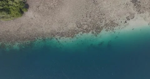 Top-down drone view of coral reef meeting deep blue ocean in West Bali National Stock Footage 331105483