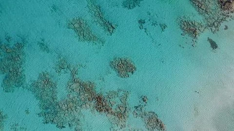 Top down drone view of crystal clear turquoise sea water with underwater re.. Stock Photos