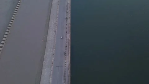 Top Down Drone View of Dam Road Between Calm Water Reservoirs Stock-Footage 338226822