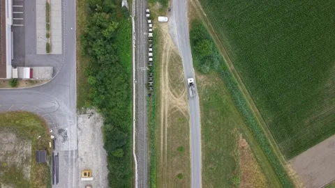 Top down drone view of dump truck working alongside railway construction site Stock Footage 339645427