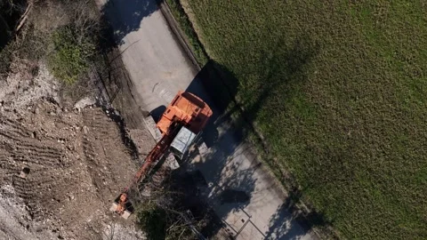 Top down drone view of excavator digging roadside trench for infrastructure Stock Footage 331790323