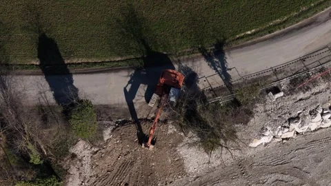Top down drone view of excavator digging roadside trench for infrastructure Stock Footage 331793534