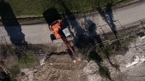 Top down drone view of excavator digging roadside trench for infrastructure Stock Footage 331793570