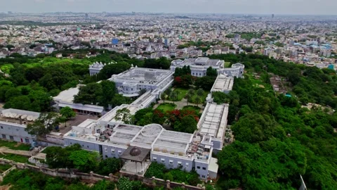 Top down drone view of falaknuma palace with trees and crowded residence 動画素材 300335052