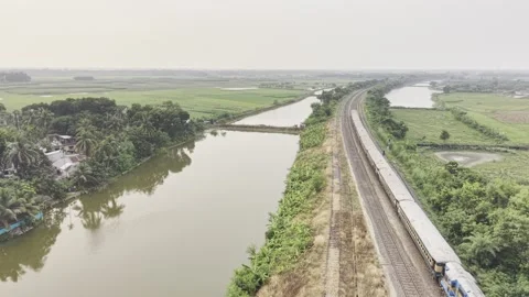 Top Down Drone View of a Fast Moving Passenger Train on Curved Railway Tracks Stock Footage 338007868