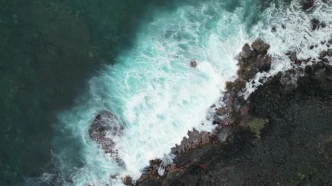 Top down drone view of foamy turquoise surf around lava in Hawaii Stock-Footage 348251063