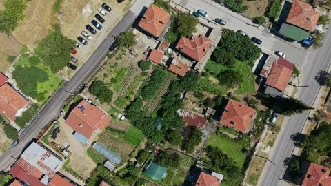 Top down drone view of gardens and cars in Varvara Bulgaria Stock Footage 348407453