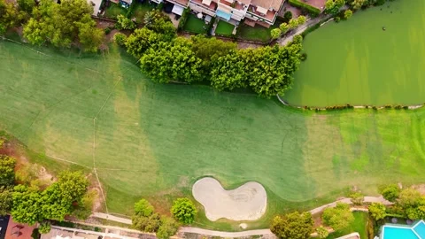 Top-down drone view of golf course pond and green landscape in Alicante, Spain Stock Footage 311357389